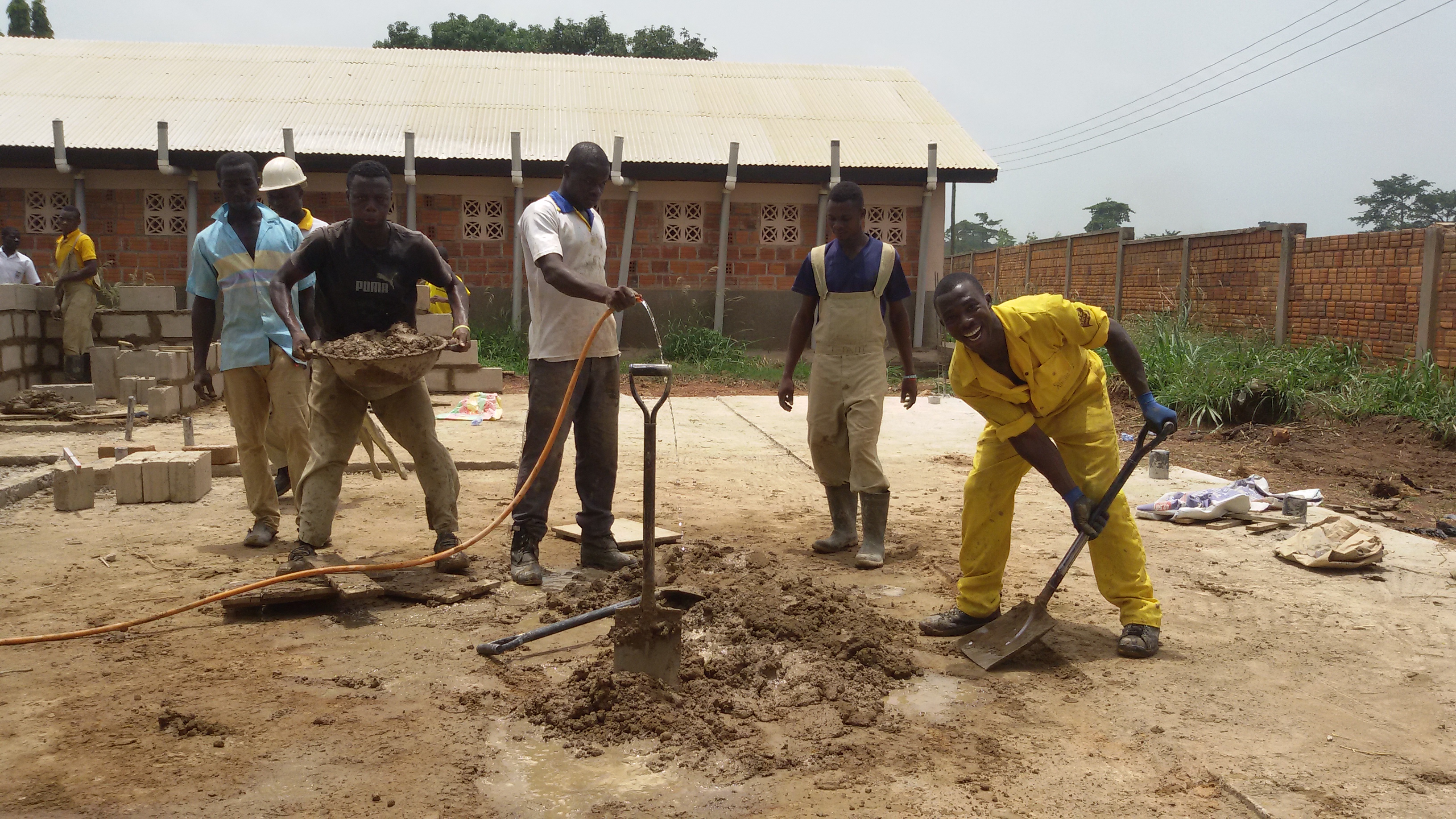 Students engaged in modern masonry, concrete work, and building construction practicals at DBTI Odumase